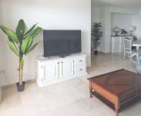A television and/or entertainment centre at Spacious Apartment with Sea View in Estepona - 140 m²