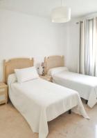 A bed or beds in a room at Spacious Apartment with Sea View in Estepona - 140 m²