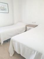 A bed or beds in a room at Spacious Apartment with Sea View in Estepona - 140 m²