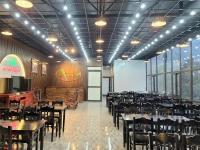 a restaurant with tables and chairs in a room at Van Anh Hotel - Restaurant in Dồng Văn