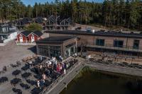 Un grupo de personas paradas afuera de un edificio en Laxhall Hotell Krog Konferens, en Torsö