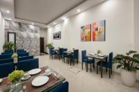 a dining room with blue chairs and tables at Queen Cafe Hotel in Hanoi