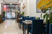 a restaurant with blue chairs and tables in a room at Queen Cafe Hotel in Hanoi