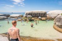 a man standing in the water at a beach at Never at Home Kloof Street in Cape Town