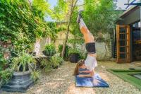 a girl doing a handstand on a yoga mat at Never at Home Kloof Street in Cape Town
