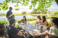 a group of people sitting around a table with wine glasses at Never at Home Kloof Street in Cape Town