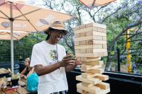 a man standing next to a stack of wooden blocks at Never at Home Kloof Street in Cape Town