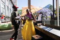 a man standing next to a woman in a yellow dress at Never at Home Kloof Street in Cape Town