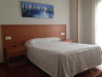 A bed or beds in a room at Hostal El Poligono