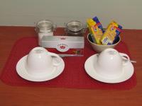 two white cups and saucers sitting on a red towel at Caledon 31 in George