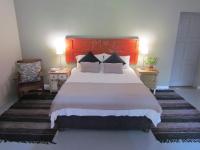 a bedroom with a large bed and two night stands at Caledon 31 in George