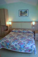 Łóżko lub łóżka w pokoju w obiekcie Hotel Arlecchino