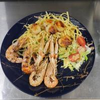 a blue plate of food with shrimp and pasta at Balzac Hôtel Restaurant in Fougères