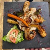 a plate of food with seafood and vegetables on a table at Balzac Hôtel Restaurant in Fougères