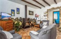 A television and/or entertainment centre at Cozy Home In Algatocin With Kitchenette