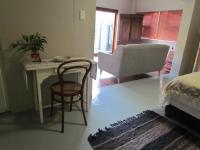 a bedroom with a bed and a table and a chair at Caledon 31 in George
