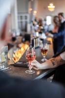 エルンシェルツビクにあるFirst Hotel Statt Örnsköldsvikのバーでワイングラスを持っている人