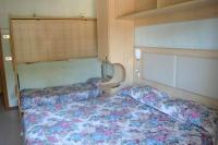 Łóżko lub łóżka w pokoju w obiekcie Hotel Arlecchino