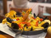 a plate of food on a table with a pan of food at Hotel Alhambra in Punta del Este