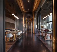 a dining room with wooden tables and chairs at voco Melbourne Central in Melbourne