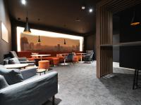 a lobby with couches and tables and a waiting room at JustStay Solingen Hotel &amp; Apartments in Solingen