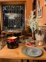 a table with a plate of food on top of it at hôtel oberland in Le Bourg-dʼOisans
