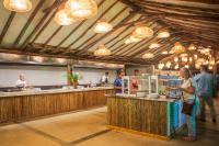 a group of people standing at a counter in a restaurant at Sunsol Isla Caribe in Puerto Fermín