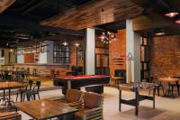 a restaurant with a pool table and tables and chairs at Fairfield by Marriott Bali South Kuta in Kuta