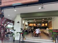 a group of people sitting at tables in a restaurant at Homestay KNK in Tawau