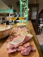 two glasses of wine and meat on a table at Nema in Mossa