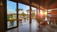 a lobby with a view of a patio with tables and chairs at Resort QSB - Um novo padrão de conforto e lazer no coração da cidade in Pirenópolis