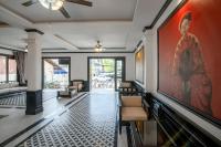 a living room with a large painting on the wall at Luang Prabang Vang Luang Hotel in Luang Prabang