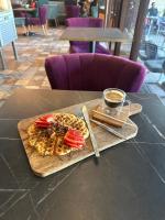 a table with a plate of food and a cup of coffee at Rachos in Oujda