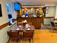 The Bell and Bottle في Hedgerley: غرفة طعام مع طاولة وكراسي وبار