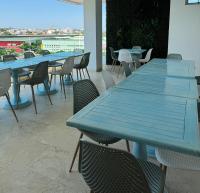 a row of blue tables and chairs on a patio at Hotel Odonata Real in Cartagena de Indias