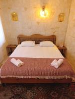 Postel nebo postele na pokoji v ubytování Asma Cave House