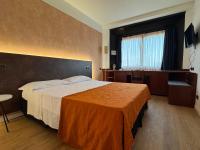 A bed or beds in a room at Hotel Sirena - B&B