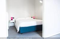 A bed or beds in a room at Brera Apartments in Garibaldi