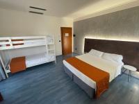 A bed or beds in a room at Hotel Sirena - B&B