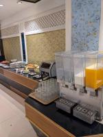 a buffet line with glasses of orange juice and food at First Pacific Cirrus in Pattaya Central