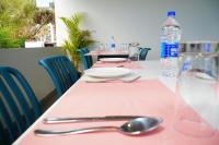a table with a pink table cloth and a bottle of water at The Clouds End in Devikolam