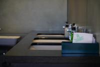 a bathroom counter with a sink and a toilet at The Clouds End in Devikolam