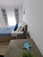 Posteľ alebo postele v izbe v ubytovaní Apartments Olive Garden