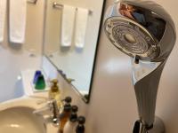 a photographer taking a picture in a bathroom mirror at Kyoto Inn Gion The Second in Kyoto