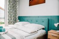 Posteľ alebo postele v izbe v ubytovaní Apartamenty Majer Łeba