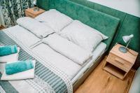 Posteľ alebo postele v izbe v ubytovaní Apartamenty Majer Łeba