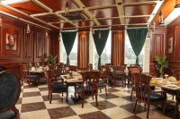 a restaurant with tables and chairs in a room at Faletti's Grand Hotel Gujranwala in Gujrānwāla