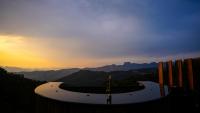 a winding road in the mountains at sunset at Chalé Boutique Spa- Sauna seca, Jacuzzi , Rede suspensa in Campos do Jordão