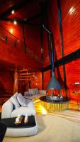 a living room with two beds and a fireplace at Chalé Boutique Spa- Sauna seca, Jacuzzi , Rede suspensa in Campos do Jordão