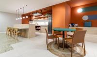 a kitchen and dining room with a green table and chairs at Flat Casa Mauá in Rio de Janeiro